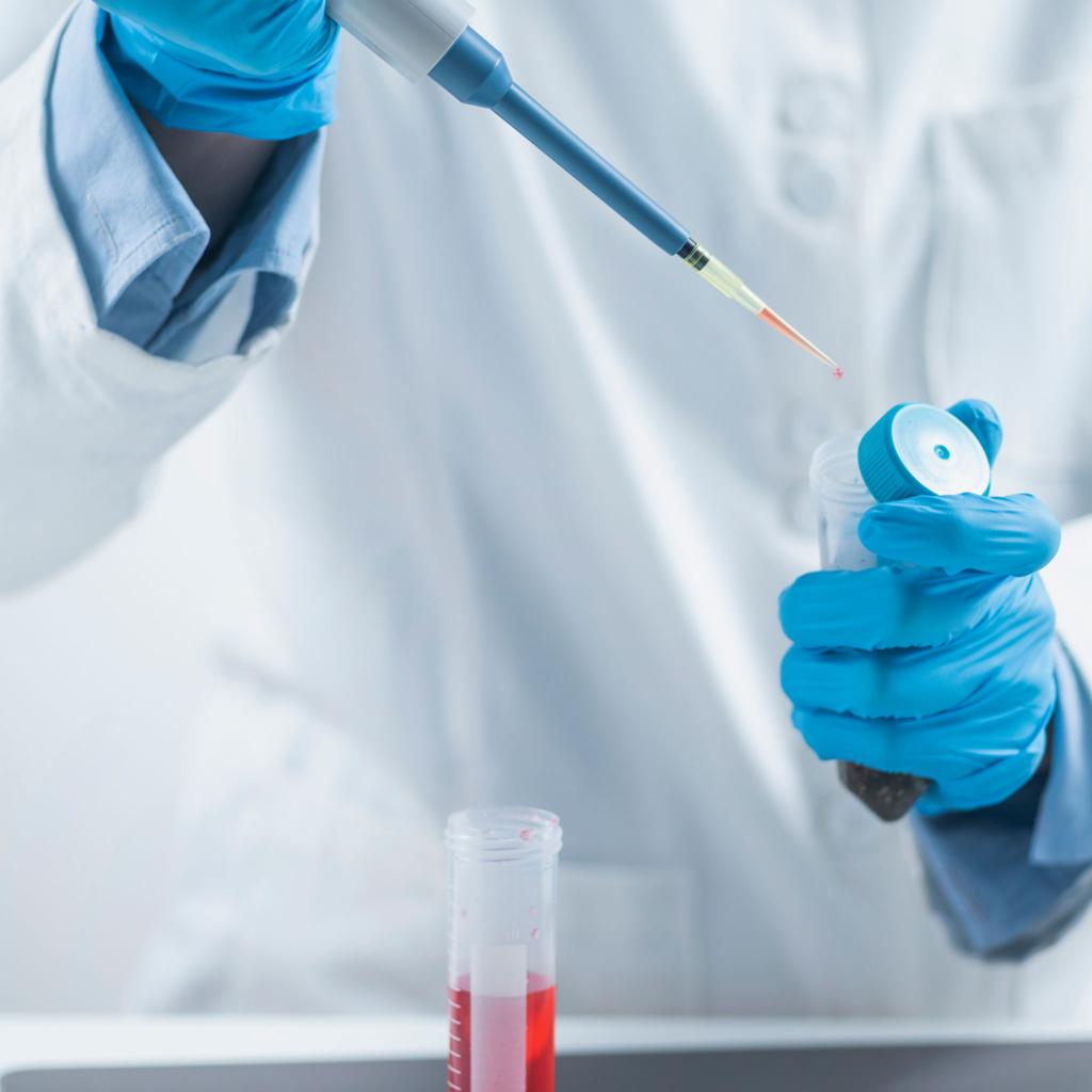 Quality inspector testing an agrochemical sample with a micropipette in a laboratory